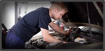 Image of a mechanic reaching into an engine block