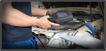Image of a man holding a vehicle measurement tool