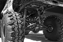Image of large tires and a suspended truck