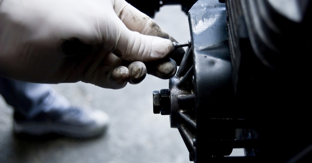 Mechanic Hand Tuning Up Engine