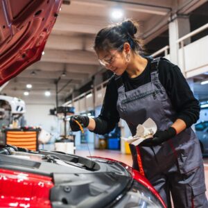 checking a car's oil dipstick to monitor fluid levels
